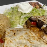 Fajita Quesadilla · Steak or grilled chicken with grilled onions and bell peppers. Served with rice.