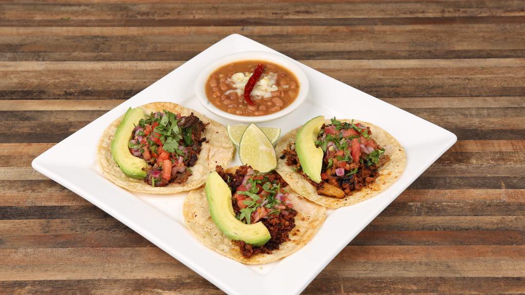 Street Tacos · Three tacos. Served with your choice of meat ( Steak, grilled chicken, chorizo, pork, brisket or pastor), pico de gallo, avocado, side of charro beans, limes and tomatillo sauce.