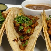 Tacos Al Pastor · Three pastor tacos stuffed with grilled pineapple, fresh cilantro and onions. Served with ri...