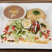Enchiladas Supremas · One ground Beef, one shredded chicken and one cheese enchilada. Covered with cheese dip, let...
