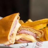 Media Noche · Ham, swiss cheese, pork, pickles and mustard on a sweet roll.