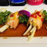Salmon Bonsai · Spicy blue crab and cucumber wrapped in sliced salmon, served with spicy ponzu, special sauc...