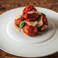 Slow Cooked Meatballs · in marinara and finished with parmesan cheese