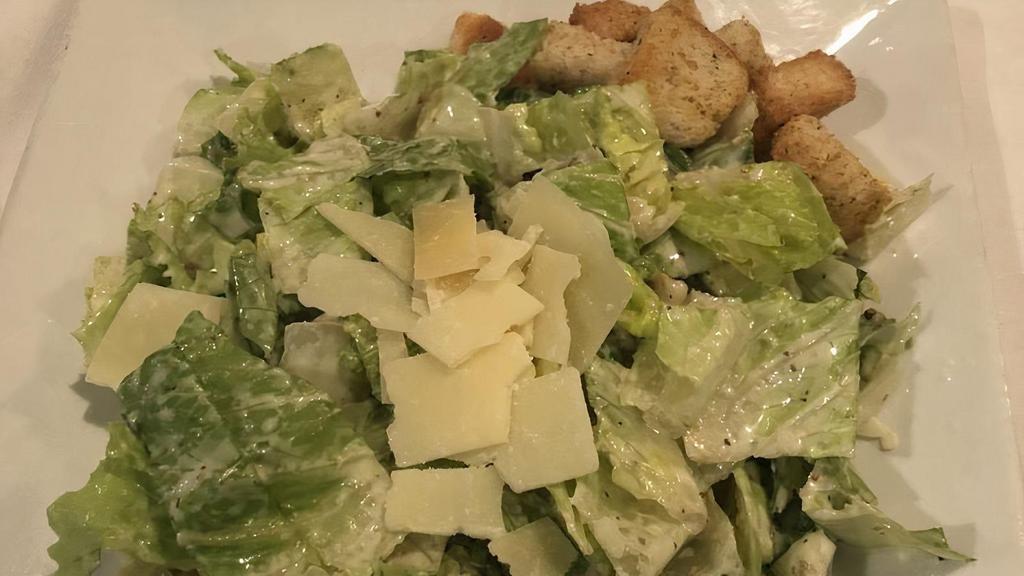 Caesar Salad · Hearts of romaine, shaved parmigiana, garlic croutons, tossed with classic Caesar dressing.