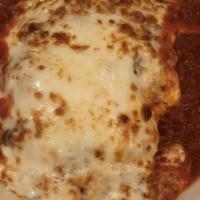 Lasagna · Layers of pasta, ricotta cheese, veal, sausage and meat sauce, herbs, baked with mozzarella ...