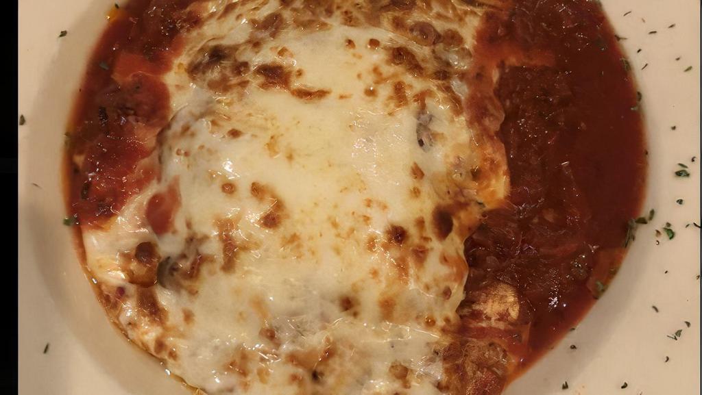Lasagna · Layers of pasta, ricotta cheese, veal, sausage and meat sauce, herbs, baked with mozzarella cheese and marinara sauce.