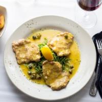 Vitello Alla Picatta · Veal scaloppini sautéed and cooked in a caper lemon white wine sauce, served with spinach in...
