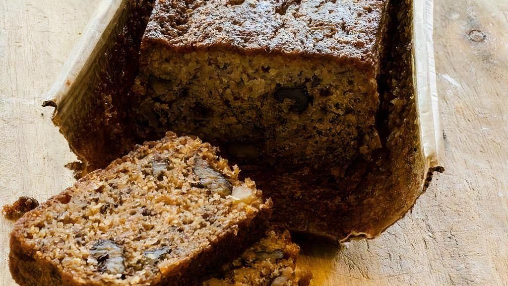 Banana Bread Slice · Moist and delicious, classic banana nut loaf, filled with crunchy walnuts and sweet overripe bananas.