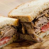 Lamb Sandwich · House roasted lamb, vine ripe tomatoes, rosemary, and red onion marmalade on house-made coun...