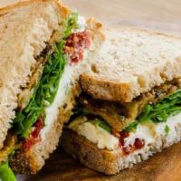 Tuscany Sandwich · Roasted eggplant, sun-dried tomatoes, goat cheese with chives & arugula on house-made whole ...
