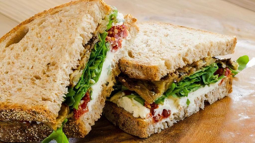 Tuscany Sandwich · Roasted eggplant, sun-dried tomatoes, goat cheese with chives & arugula on house-made whole wheat bread.