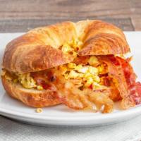 Croissant W/ Scr Eggs & Bacon · Eggs with bacon.