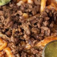 Carne Asada & Fries · Bed of fries covered with melted cheese and topped with carne asada. Comes with a side of gu...
