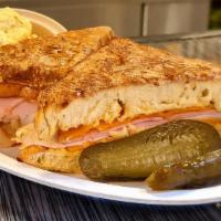 Famous Monte Cristo Sandwich Lunch · Layers of bread, ham, turkey, and swiss cheese are dipped in an egg batter, and grilled.
