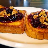 French Toast With Blueberry And Walnuts · Sourdough bread dipped in a rich egg batter, served golden brown, lightly dusted with powder...