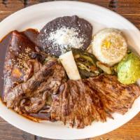 Tampiqueña · Flank steak served with a mole enchilada, rajas, rice, refried beans and tortillas.