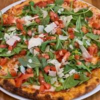 Moderna · Tomato sauce, mozzarella, arugula, diced tomatoes and shaved grana padano cheese.