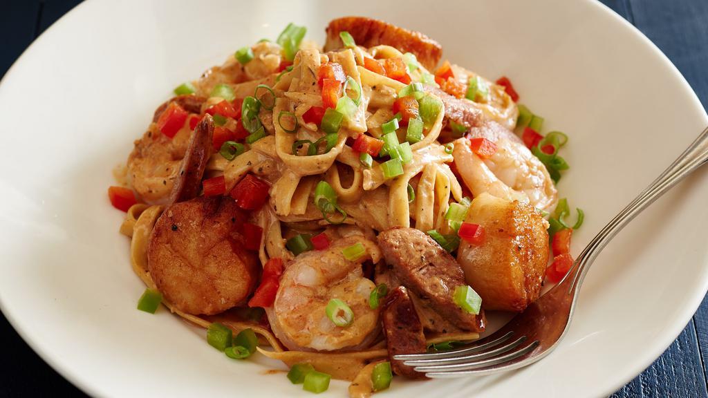 Cajun Seafood Fettuccine · New Bedford jumbo sea scallops and sautéed shrimp, tossed in Cajun cream sauce with Andouille sausage, green and red peppers.