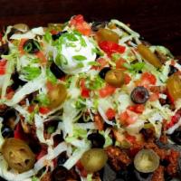 Tavern Nachos   · Topped with your choice of black beans and/or spicy ground beef with mixed cheeses, salsa, l...