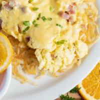 Country Benedict · Hash browns with grilled onions topped with scrambled eggs and country ham. Cover it with cr...
