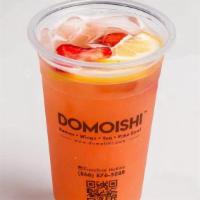 Peach Berry Green Tea · Sparkling green tea infused with peach and berry, topped with fresh fruit.