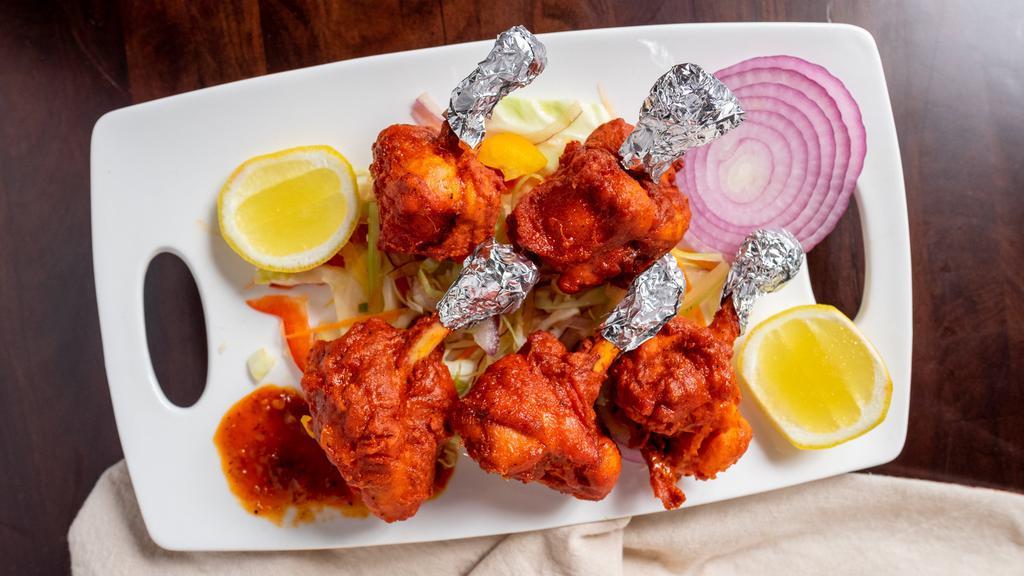 Tandoori Chicken · Chicken marinated in yogurt blended with fresh ginger garlic, herbs, spices overnight and then cooked in a tandoor clay oven.