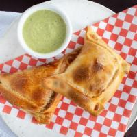 Chilean Empanada · Baked empanada with Ground beef, hard-boiled eggs, and black olives.