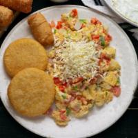 El Venezolano · Three scrambled eggs with ham, cheese, tomato, onions, green peppers, two arepitas, nata and...