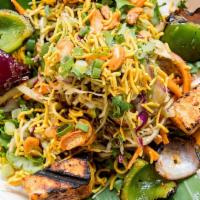 Desi Salad · Shredded red and white cabbage, carrots, scallions, and roasted cashews topped with sesame s...