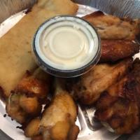 Tamales Chilangos · Three lightly fried chicken or pork tamales, topped with cheese dip, lettuce, sour cream, pi...