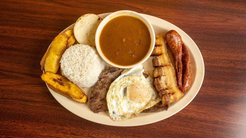 Bandeja Paisa · Typical Colombian platter with rice, beans, pork skin, fried eggs, grilled steak, corn patty, sweet plantain, and sausage.
