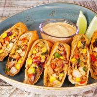 Caribbean Chicken Egg Rolls · Caribbean spiced roasted chicken, corn, red peppers, onions, and shredded cheese served with...