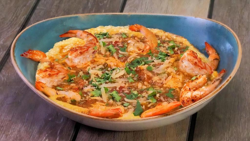 Lousiana Cajun Shrimp And Grits · Cheddar cheese grits topped with sautéed shrimp and our homemade Andouille sausage gravy
