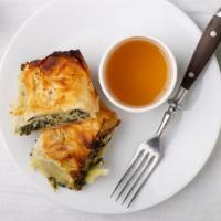 Spanakopita · Phyllo dough filled with spinach and cheese with yia yias syrup on the side.