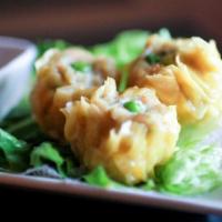 Steamed Dumplings · Steamed fresh wonton wrapped with seasoned minced chicken; served with light soy dip.