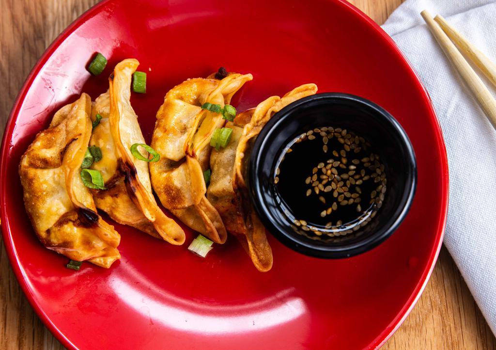 Fried Pork Gyoza (6) · Fried pork dumplings with house ginger soy dipping sauce.