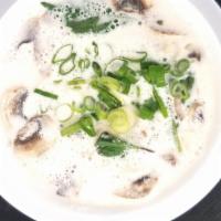 Tom Kha · Coconut herb soup cooked with mushroom and basil.