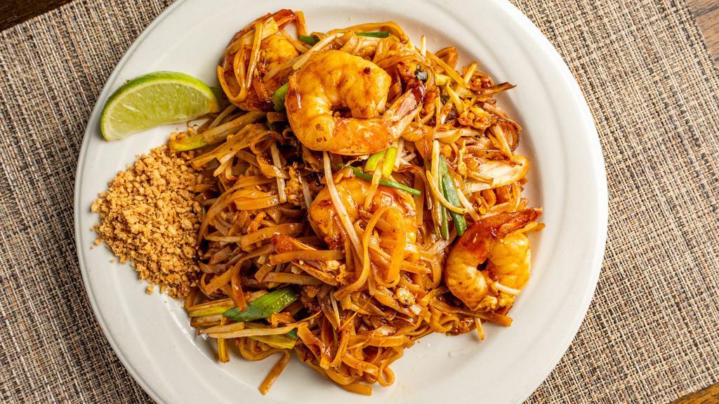 Pad Thai · Thai most famous stir fried noodle dish, stir fried thin rice noodles with egg, scallion and bean sprout with crusted peanut and lime on the side.