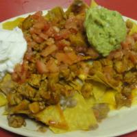 27) Nachos · Fried tortilla chips topped with beans, your choice of meat, melted mozzarella and cheddar c...