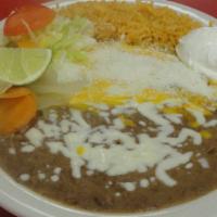 23) Enchiladas Al Cazador · 3 Enchiladas corn tortillas lightly grilled. Your choice of meat inside. Topped with our ver...