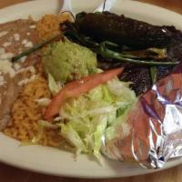 8) Carne Asada · 2 pieces of steak with a grilled jalapeno, grilled green onions, guacamole, rice, beans, let...