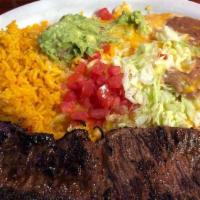 Carne Asada A La Tampiquena · Skirt steak grilled to your own taste and garnished with two cheese enchiladas, guacamole, r...