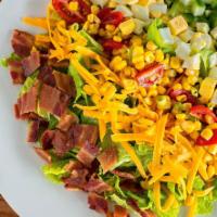 Cobb Salad · Crisp romaine lettuce, crumbled bacon, chopped egg, tomato and corn relish, cheddar cheese, ...