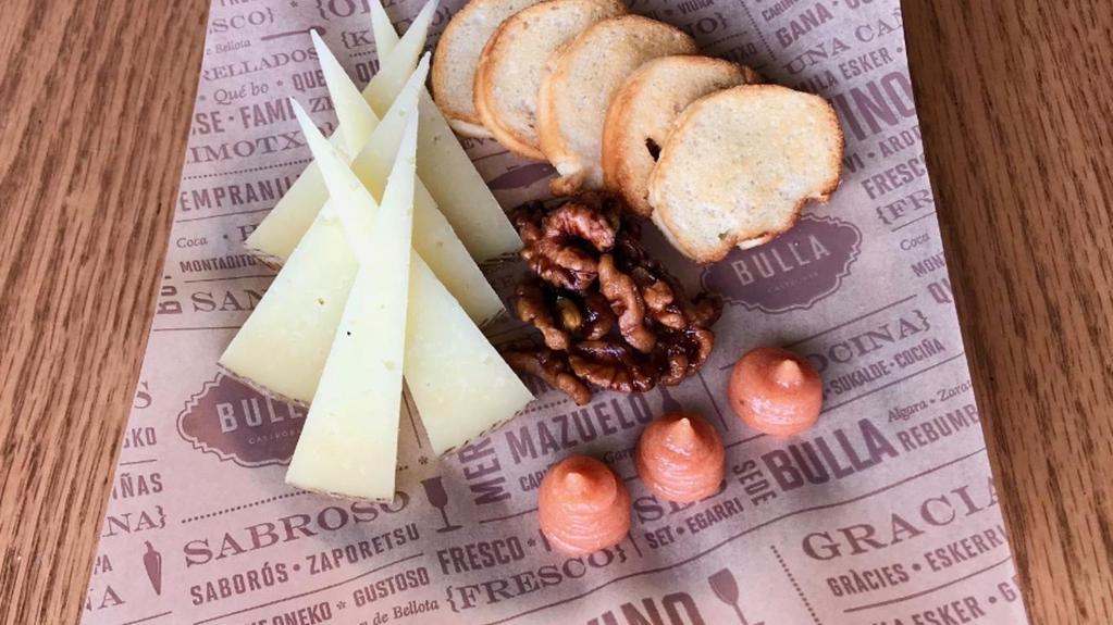 Manchego · Sheep's milk, nutty, sweet, tangy flavor. Served with caramelized walnuts, quince jam and crostini