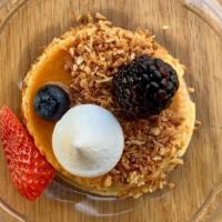 Coconut Flan · Coconut infused Spanish style creme caramel, toasted coconut, mixed berries, Swiss meringue