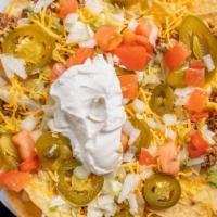 Super Nachos
 · Chips, Cheese Dip, Beef, Lettuce, Tomatoes, Onions, Shredded Cheese and Sour Cream, with or ...