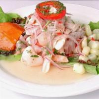 Ceviche De Mariscos · Camarones, mejillones, pulpo, y calamares cocinado en jugo de limon.(Shrimp, mussels, octopu...