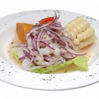 Ceviche De Pescado Y Camarones · Corvina y camarones cocinado en jugo de limon. (Seabass fish and shrimp marinated in lime ju...