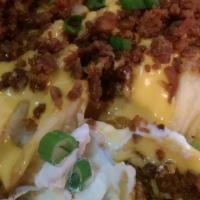 Smothered Seasoned Fries · Season fries smothered in a jalapeno queso sauce, topped with sour cream, bacon bits, and sc...
