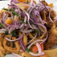 Jalea De Mariscos · Fried fish, squid, octopus and shrimp with fried yucca, onions and tomatoes salad on the top